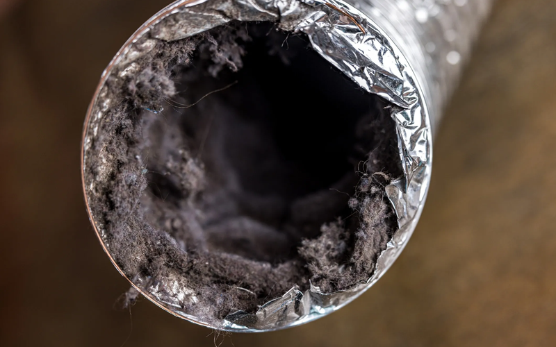 Air duct cleaning technician with HVAC equipment