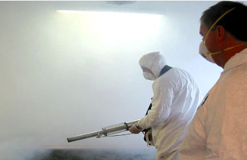 Technician applying odor elimination treatment